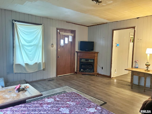 living room featuring hardwood / wood-style floors and wood walls