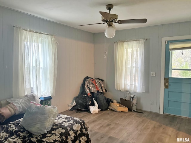 bedroom with ceiling fan and hardwood / wood-style flooring