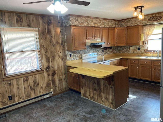 kitchen with wooden walls, sink, kitchen peninsula, white electric range, and baseboard heating