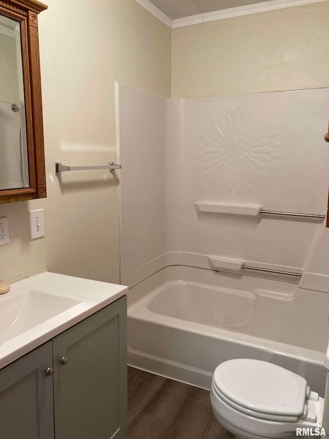 full bathroom with tub / shower combination, hardwood / wood-style floors, vanity, crown molding, and toilet