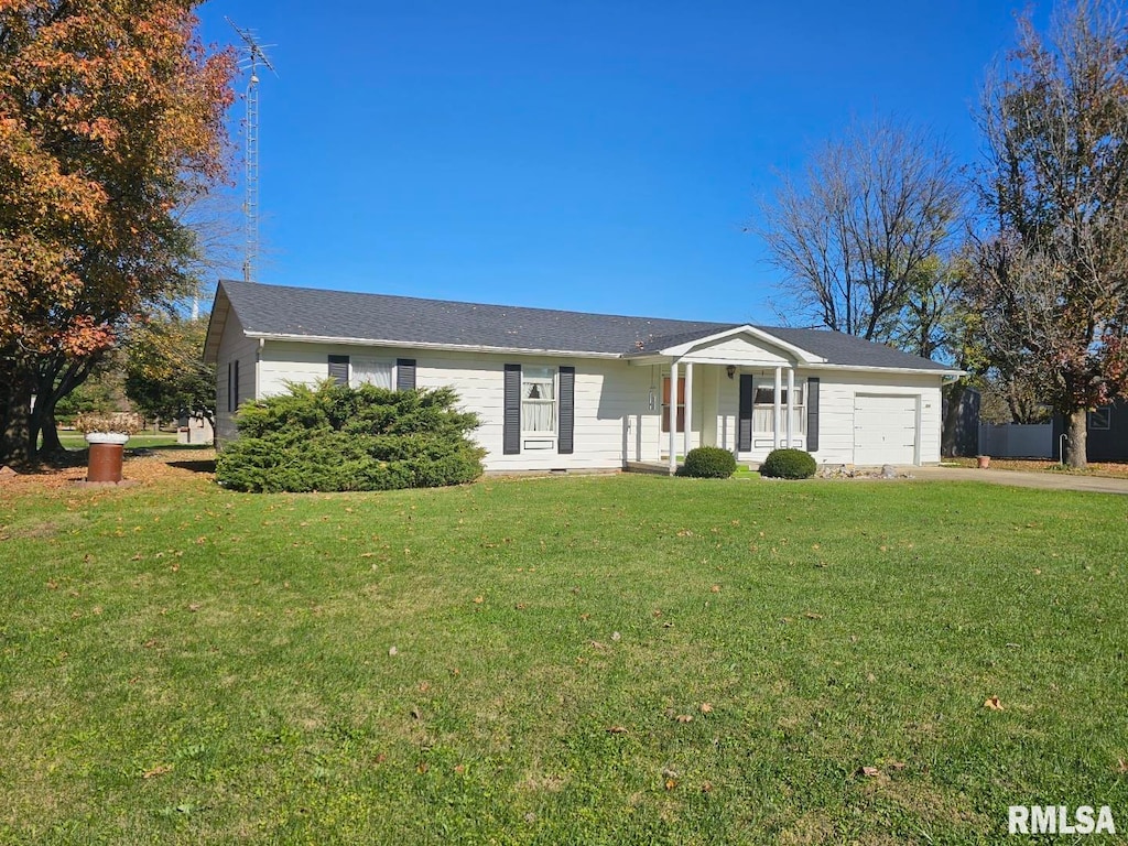 ranch-style house featuring a garage, a front lawn, and covered porch