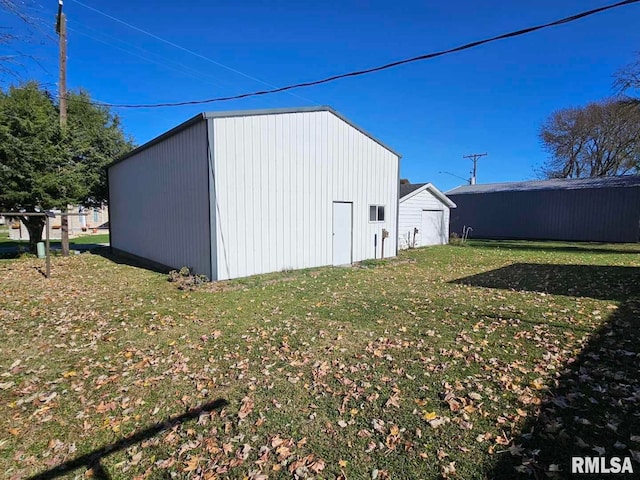 view of outdoor structure featuring a lawn