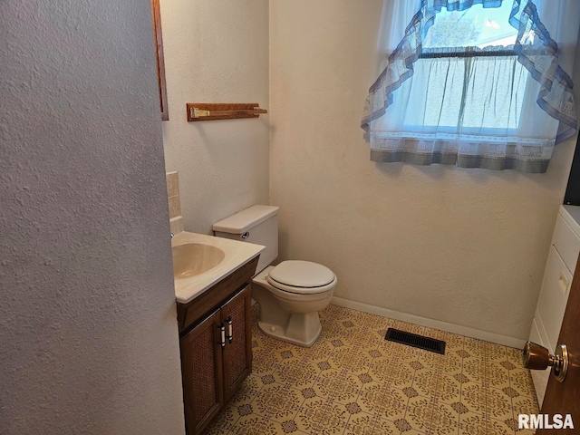 bathroom featuring vanity and toilet