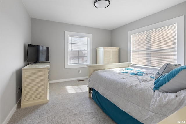 bedroom featuring light carpet