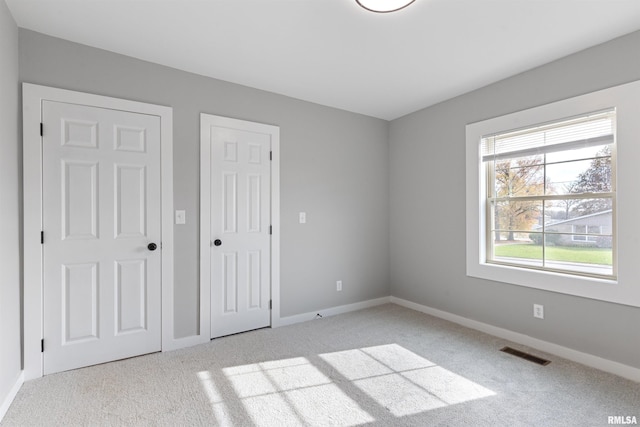 unfurnished bedroom with light carpet