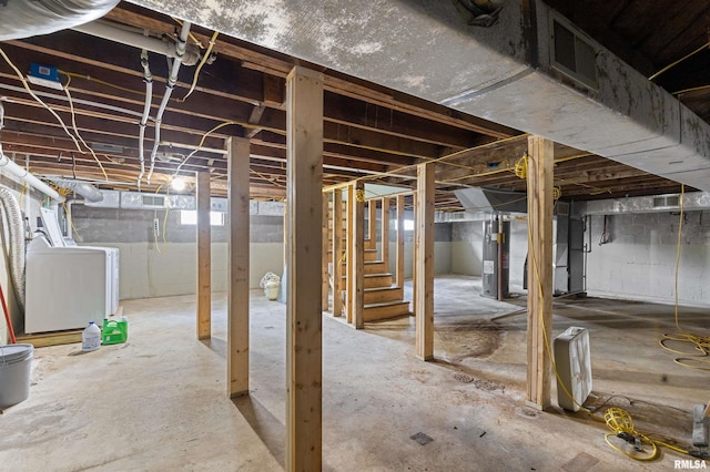 basement with electric water heater and washer / clothes dryer