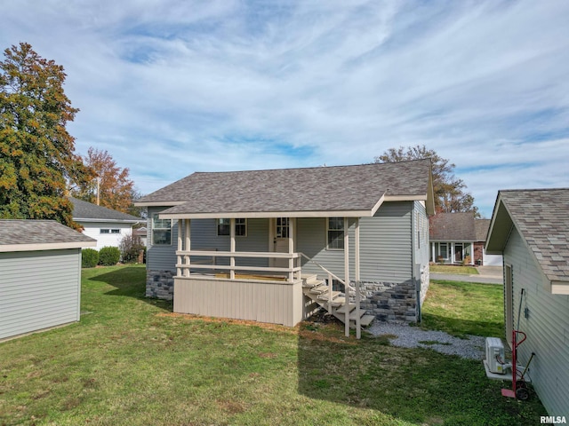 bungalow-style home with covered porch and a front yard