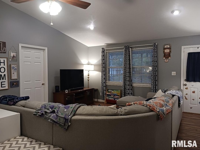 living room with ceiling fan, hardwood / wood-style floors, and vaulted ceiling