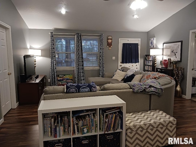 living room featuring dark hardwood / wood-style flooring, ceiling fan, and lofted ceiling