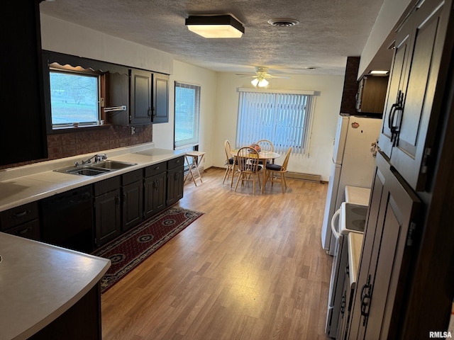 309 E Gelston St, Valier, IL 62891 - kitchen with electric range, black dishwasher, healthy amount of natural light, light wood finished floors, and a textured ceiling