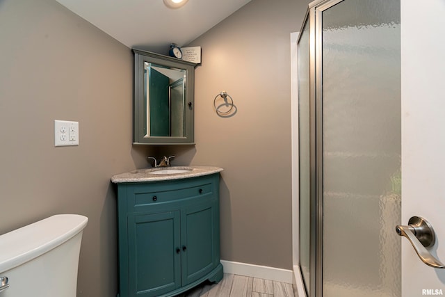 75 Bedrock Rdg, Elkville, IL 62932 - bathroom with baseboards, toilet, vanity, lofted ceiling, and a stall shower