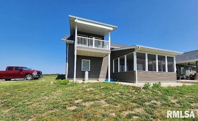 75 Bedrock Rdg, Elkville, IL 62932 - rear view of house with a balcony, a sunroom, and a lawn