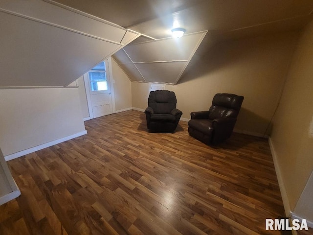 bonus room with lofted ceiling and dark hardwood / wood-style floors