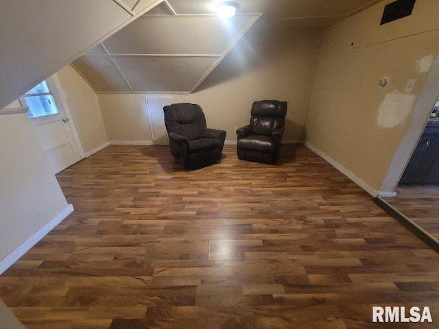 unfurnished room featuring lofted ceiling and dark hardwood / wood-style flooring