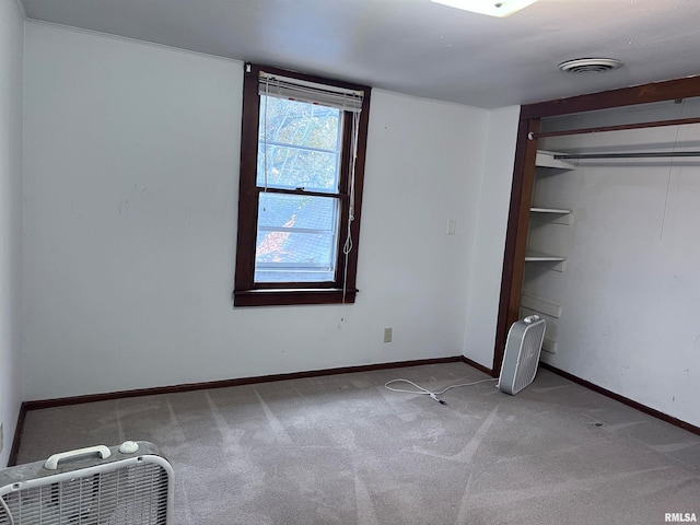 unfurnished bedroom with carpet flooring and a closet