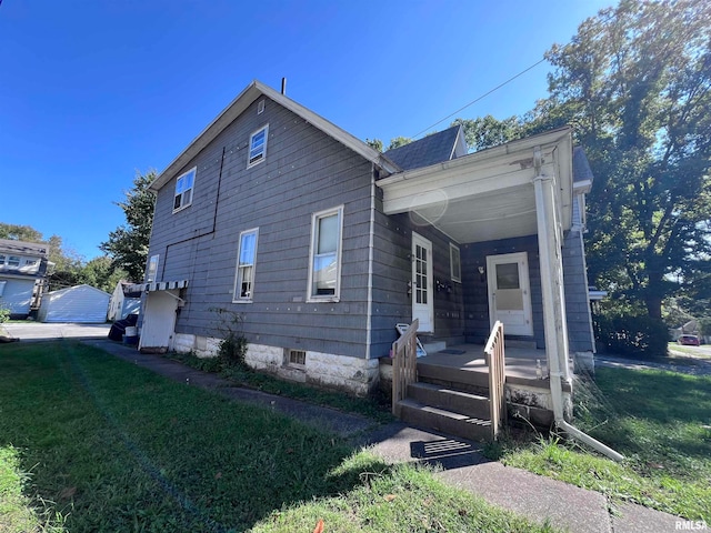 view of side of home with a yard