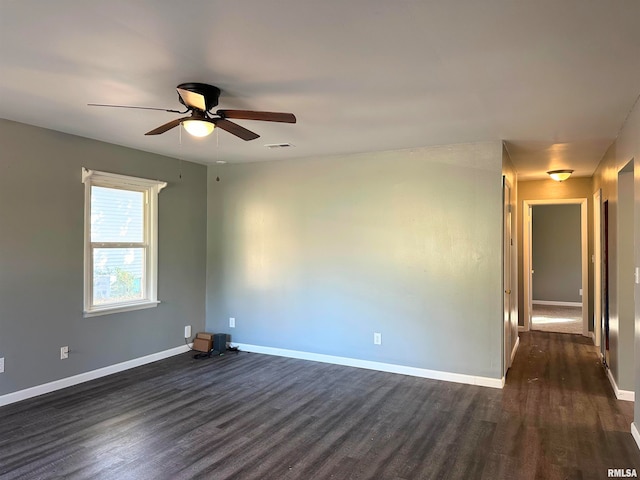 spare room featuring ceiling fan and dark wood-type flooring