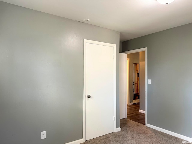 unfurnished bedroom featuring carpet floors and a closet