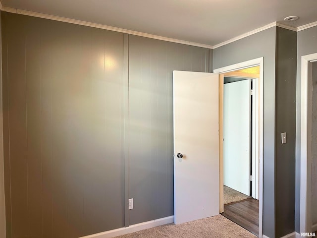 unfurnished bedroom featuring a closet, carpet, and ornamental molding