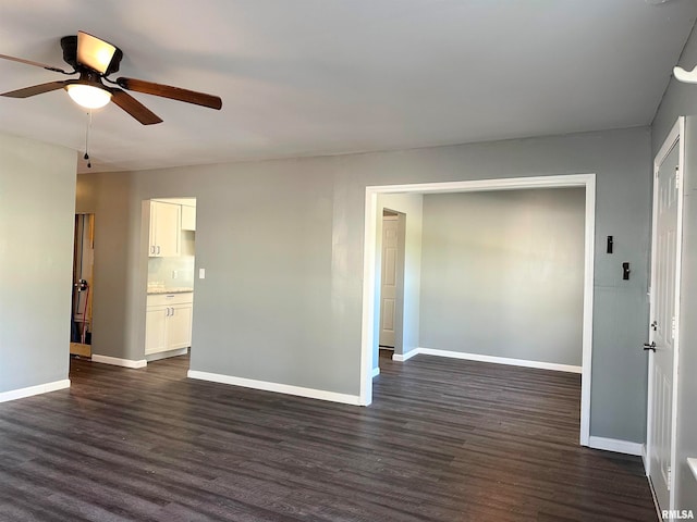 empty room featuring dark hardwood / wood-style flooring and ceiling fan