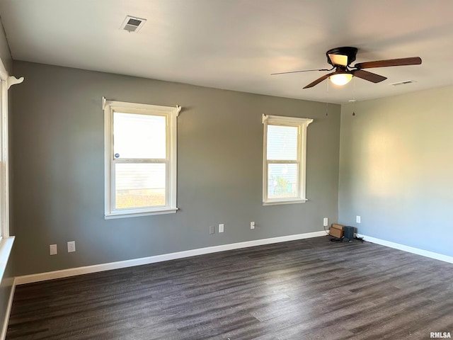 unfurnished room featuring ceiling fan, dark hardwood / wood-style flooring, and a healthy amount of sunlight