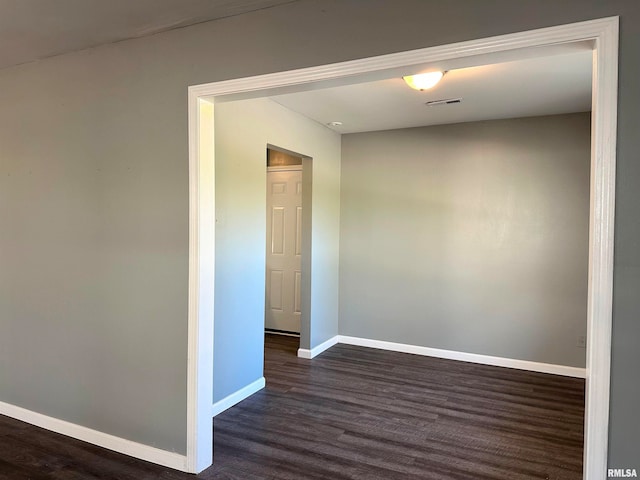 unfurnished room featuring dark hardwood / wood-style floors