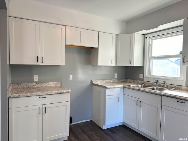 kitchen featuring white cabinetry, sink, and dark wood-type flooring