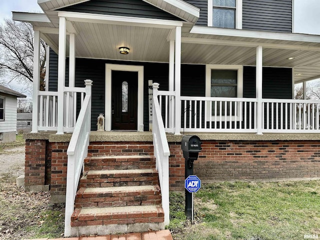 view of exterior entry featuring a porch