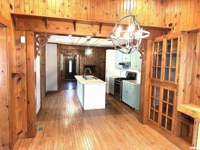 entrance foyer featuring dark hardwood / wood-style flooring, a wealth of natural light, and an inviting chandelier