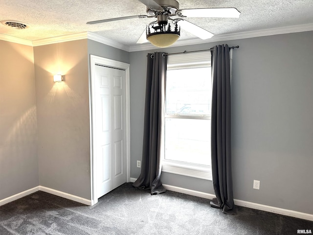 unfurnished bedroom featuring carpet flooring, a textured ceiling, ceiling fan, and crown molding