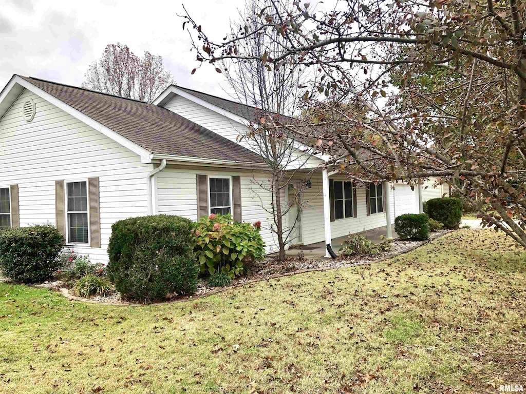 view of property exterior with a lawn