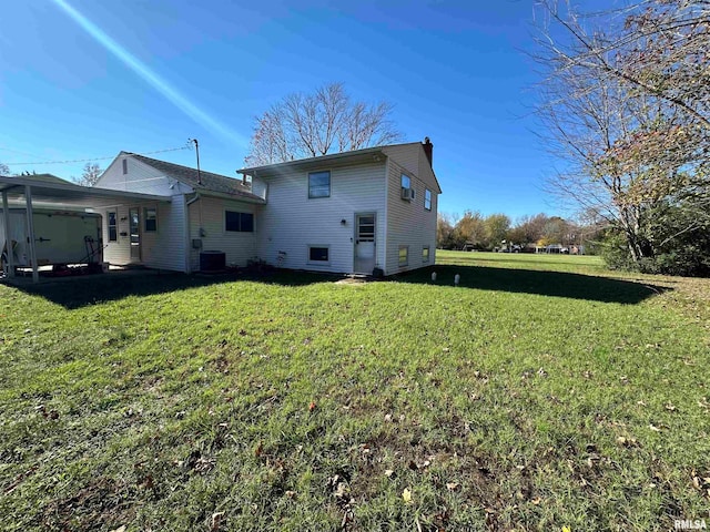 rear view of property with central AC and a lawn