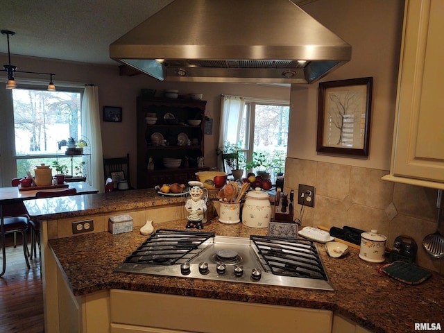 20366 Noisy Goose Ln, Olive Branch, IL 62969 - kitchen with island range hood, stainless steel gas stovetop, a peninsula, decorative backsplash, and white cabinetry