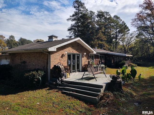 20366 Noisy Goose Ln, Olive Branch, IL 62969 - rear view of house featuring brick siding, a deck, and a lawn