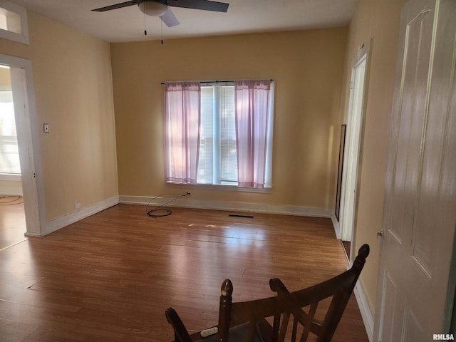 spare room featuring wood-type flooring and ceiling fan