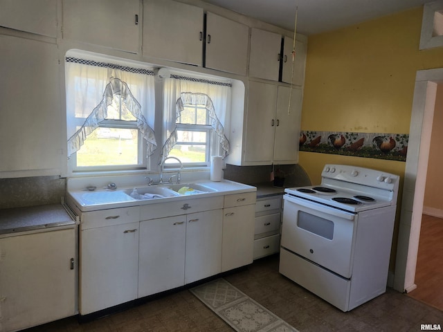 kitchen featuring dark hardwood / wood-style flooring, white cabinetry, white range with electric stovetop, and sink