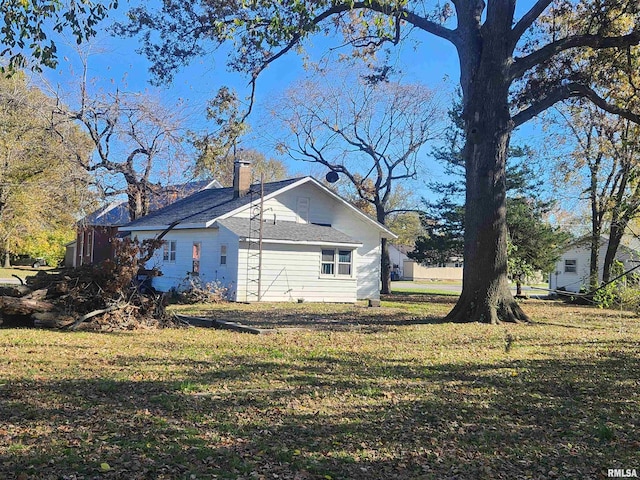 view of side of home featuring a yard