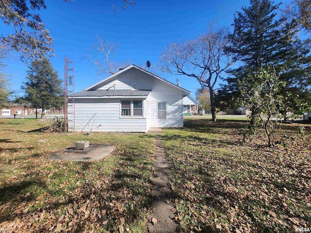 view of side of home featuring a lawn