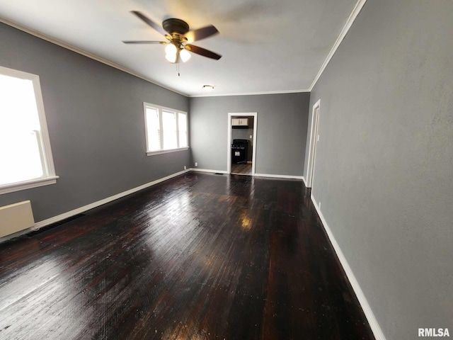 spare room featuring ceiling fan, wood-type flooring, and ornamental molding