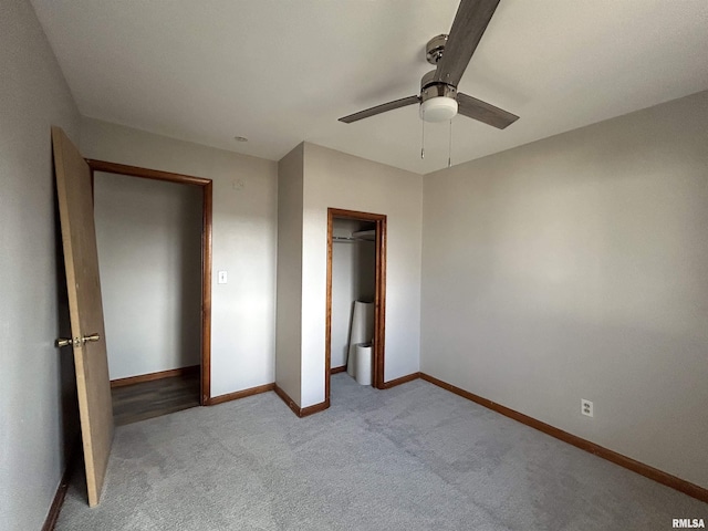 unfurnished bedroom with ceiling fan, light colored carpet, and a closet