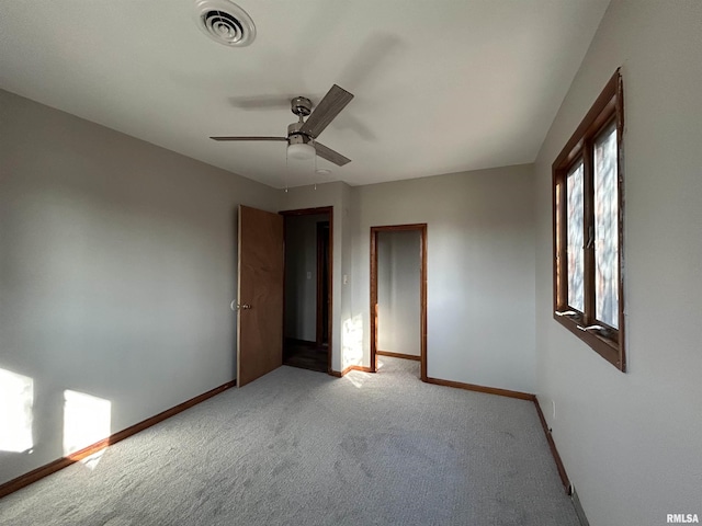 carpeted spare room with ceiling fan