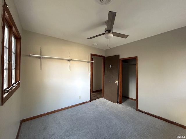 unfurnished bedroom with carpet floors, ceiling fan, and a closet