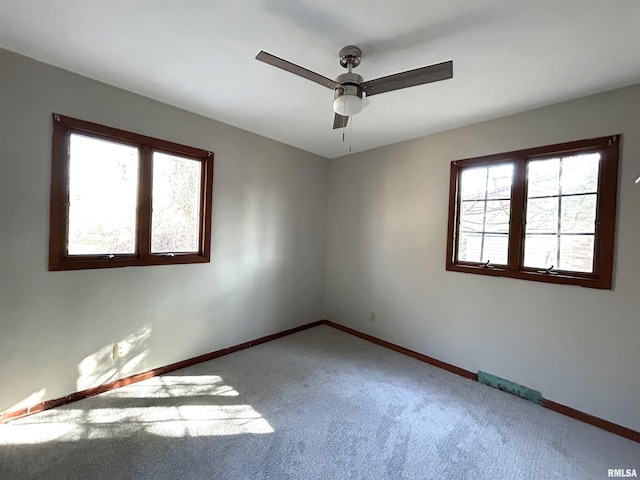 spare room featuring carpet flooring and ceiling fan