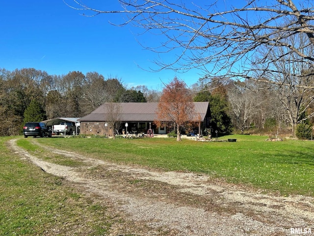 view of front of home with a carport and a front lawn