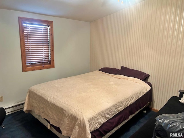 carpeted bedroom featuring a baseboard heating unit