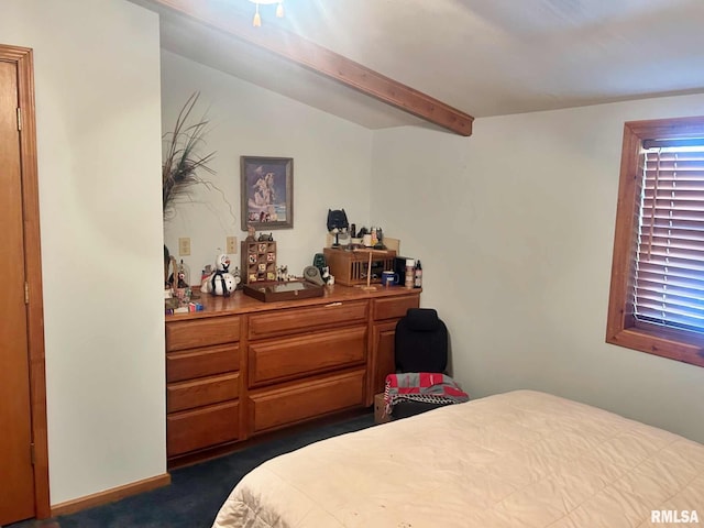 carpeted bedroom with lofted ceiling with beams