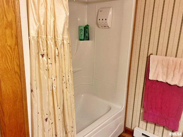 bathroom featuring shower / bath combination with curtain and a baseboard radiator