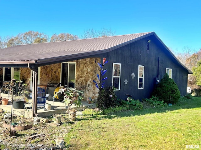 back of property featuring a yard and a patio