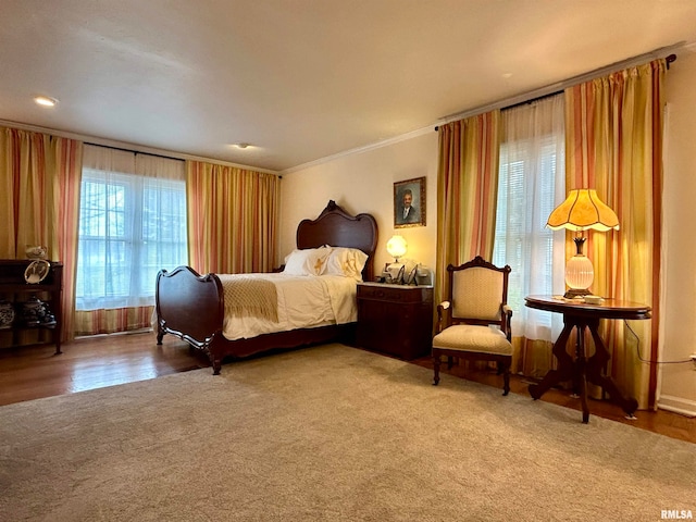 bedroom featuring crown molding and hardwood / wood-style flooring