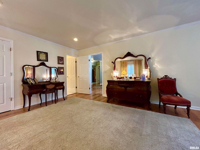 living area featuring hardwood / wood-style flooring and ornamental molding